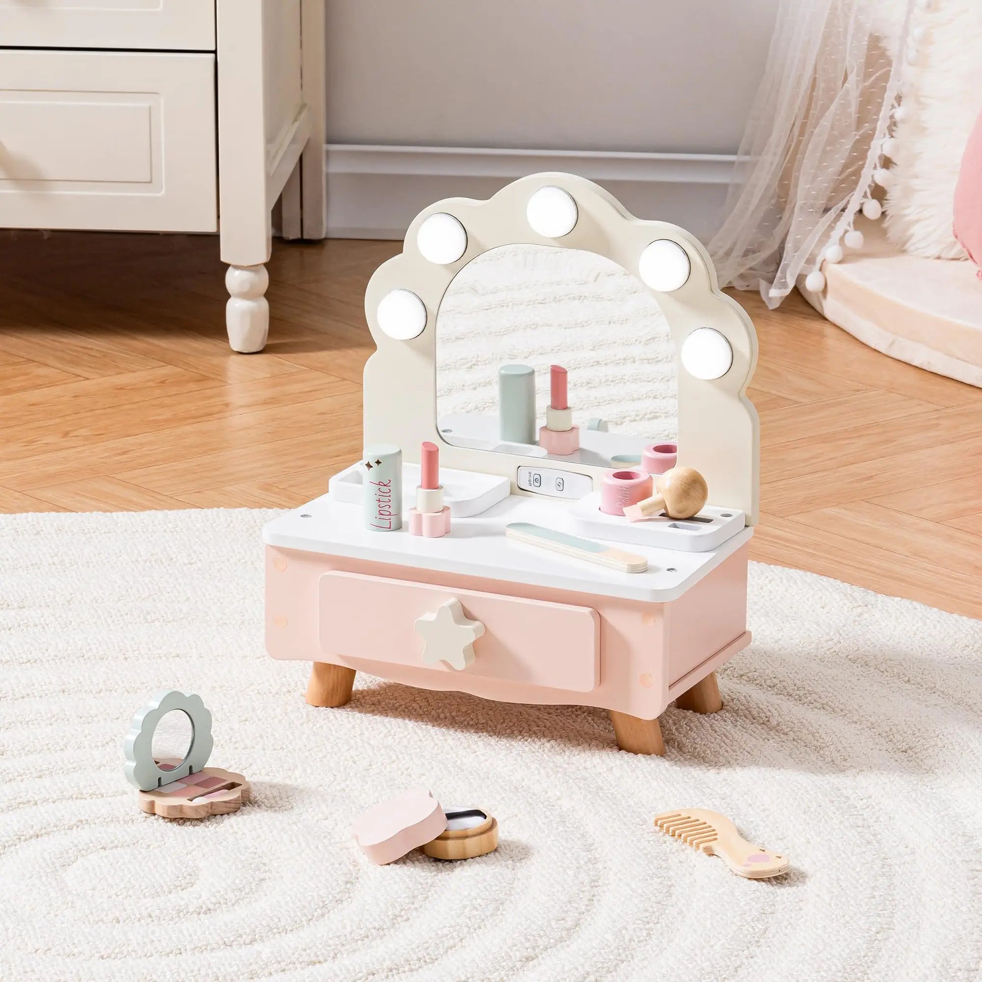 Children's vanity set with mirror and toys on a carpeted floor.
