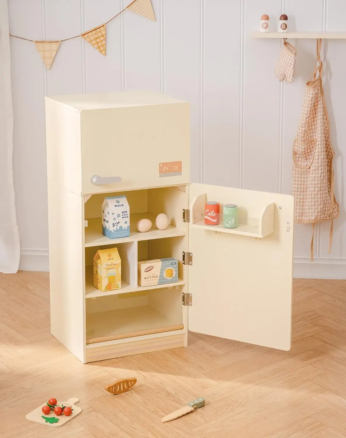 Children's play kitchen set with shelves and toy food items on a wooden floor.