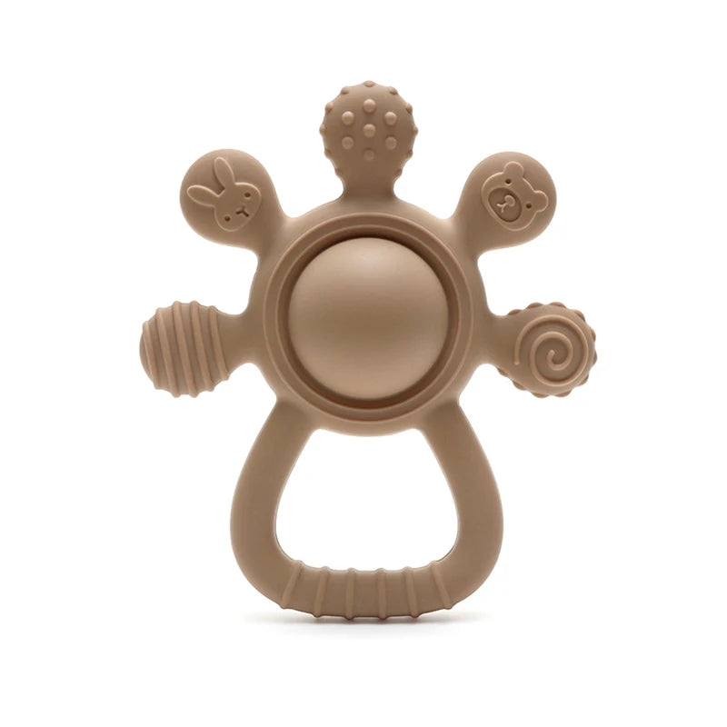 Brown baby teething ring with animal faces on a white background