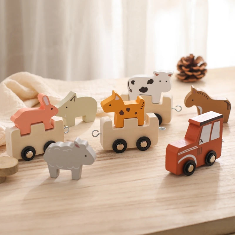 Wooden tractor and farm animal carriages on a table