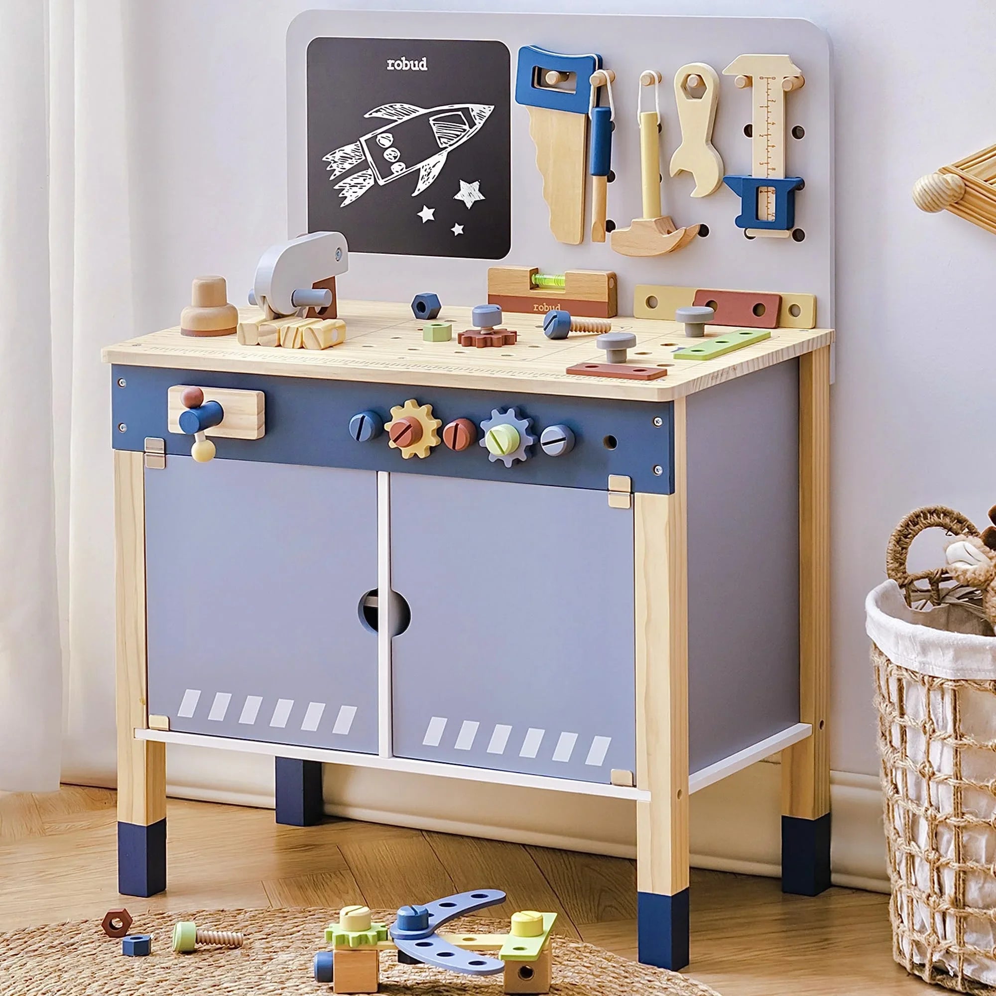 Children's play table with toy tools and a chalkboard on a light-colored floor.