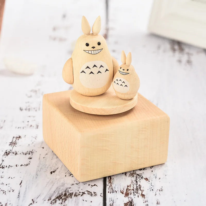 Wooden figurine of a cartoon character on a wooden block with a white  | Oliver & Company Montessori toysbackground
