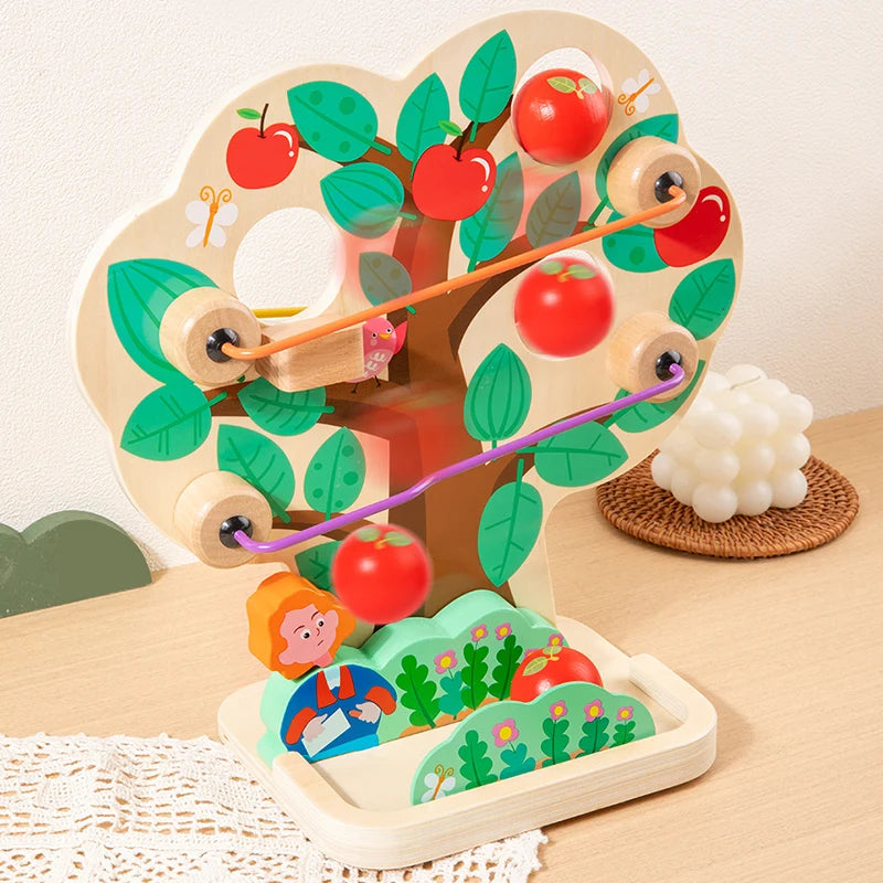 Wooden educational toy with apples and a caterpillar on a light wooden surface.