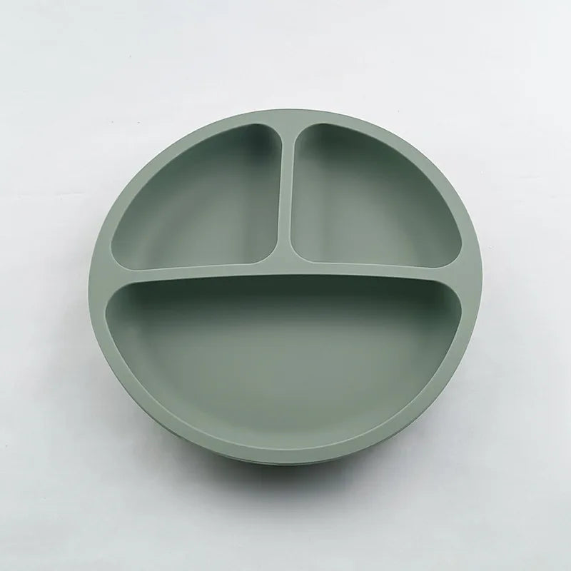 Green silicone plate with three sections on a white background