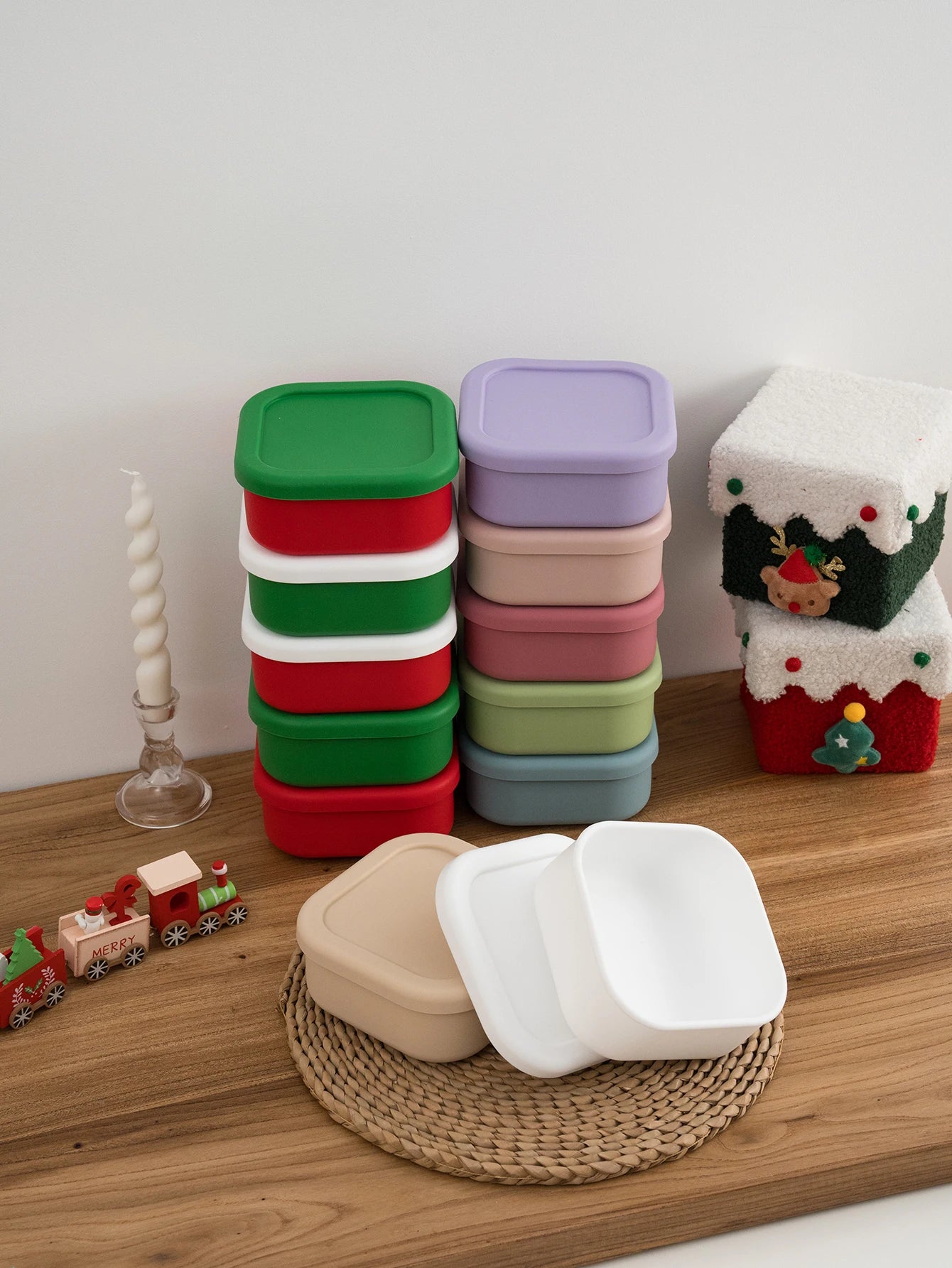 Stacked silicone snack containers in many colors beside holiday decor