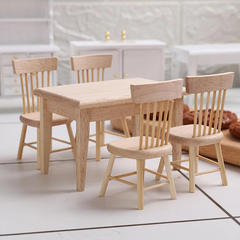 Wooden dining table with four chairs on a light-colored floor.