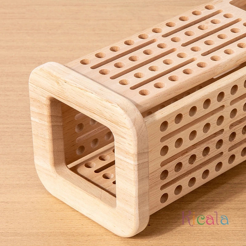 Wooden puzzle box with circular holes on a wooden surface, featuring the brand 'Kicala'.