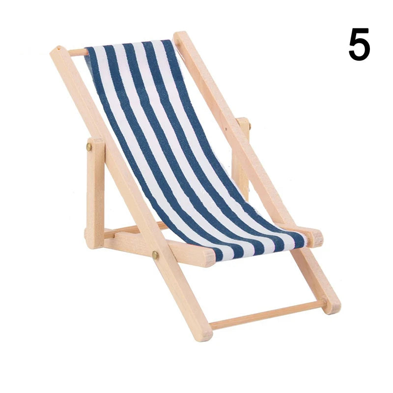 Small deck chair with blue and white striped seat on a white background