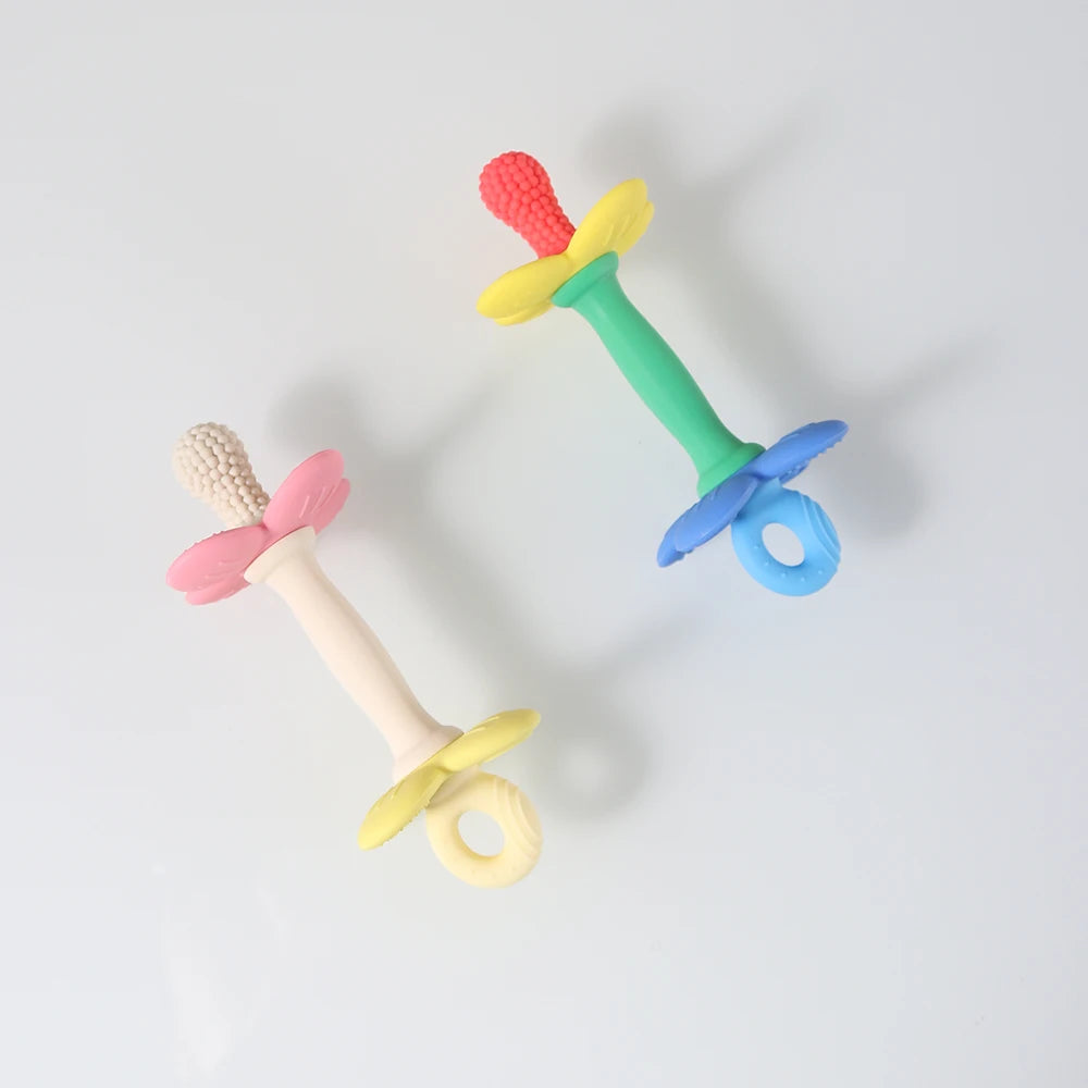 Two colorful baby teething toys on a light gray background