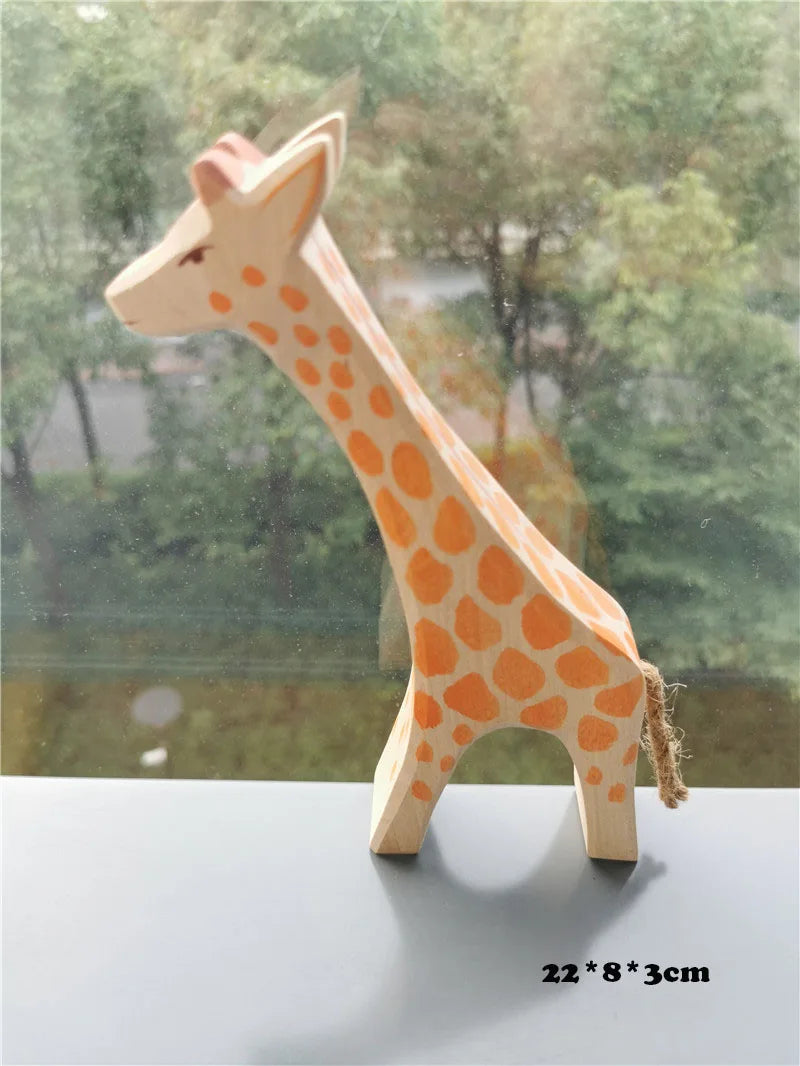 Wooden giraffe figurine on a reflective surface with a blurred natural background