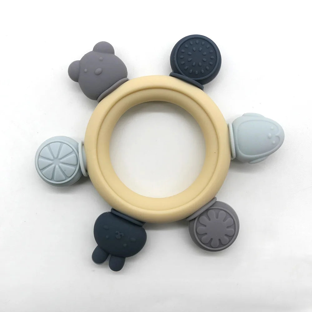 Silicone teething ring with multiple attachments on a white background