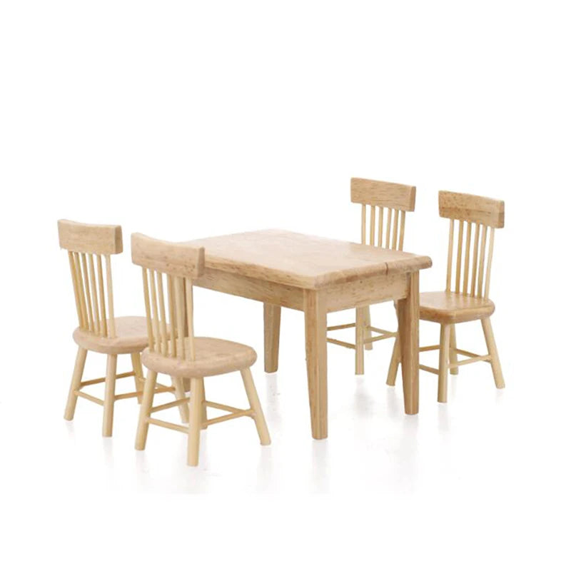 Wooden dining table with four matching chairs on a white background