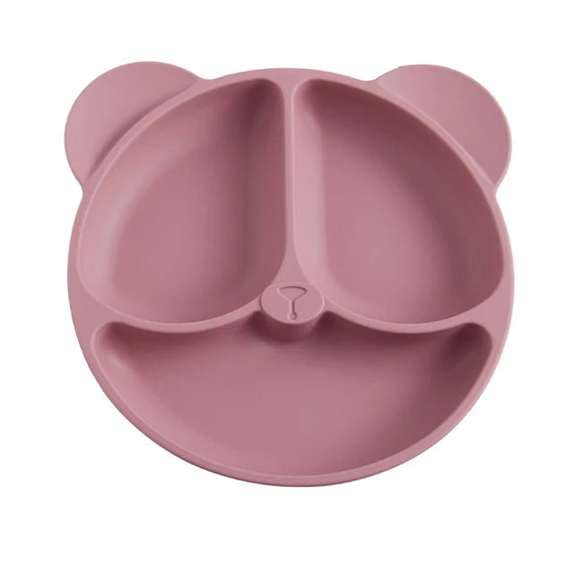 Pink bear-shaped plate on a white background