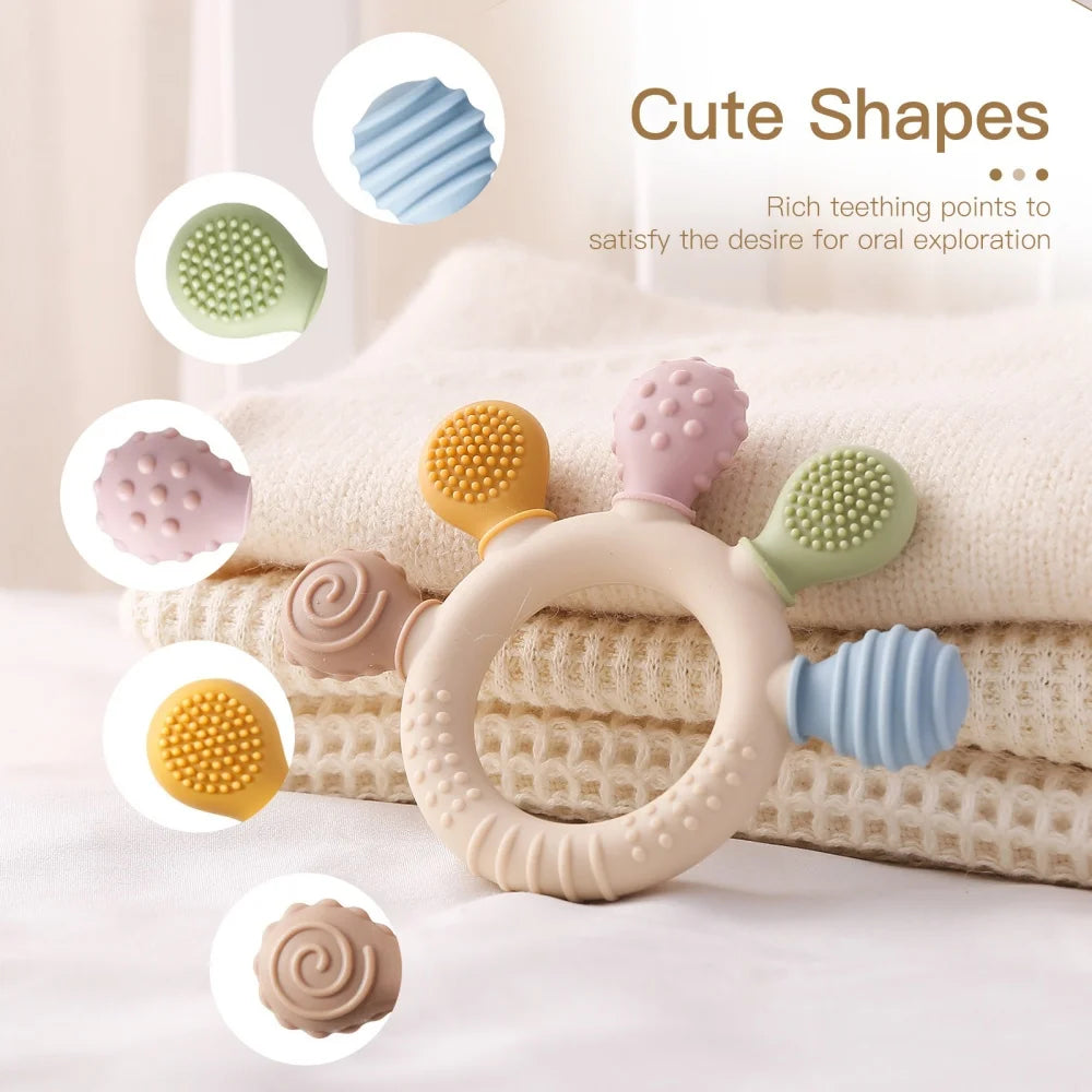 Teething ring with various textured shapes on a soft background