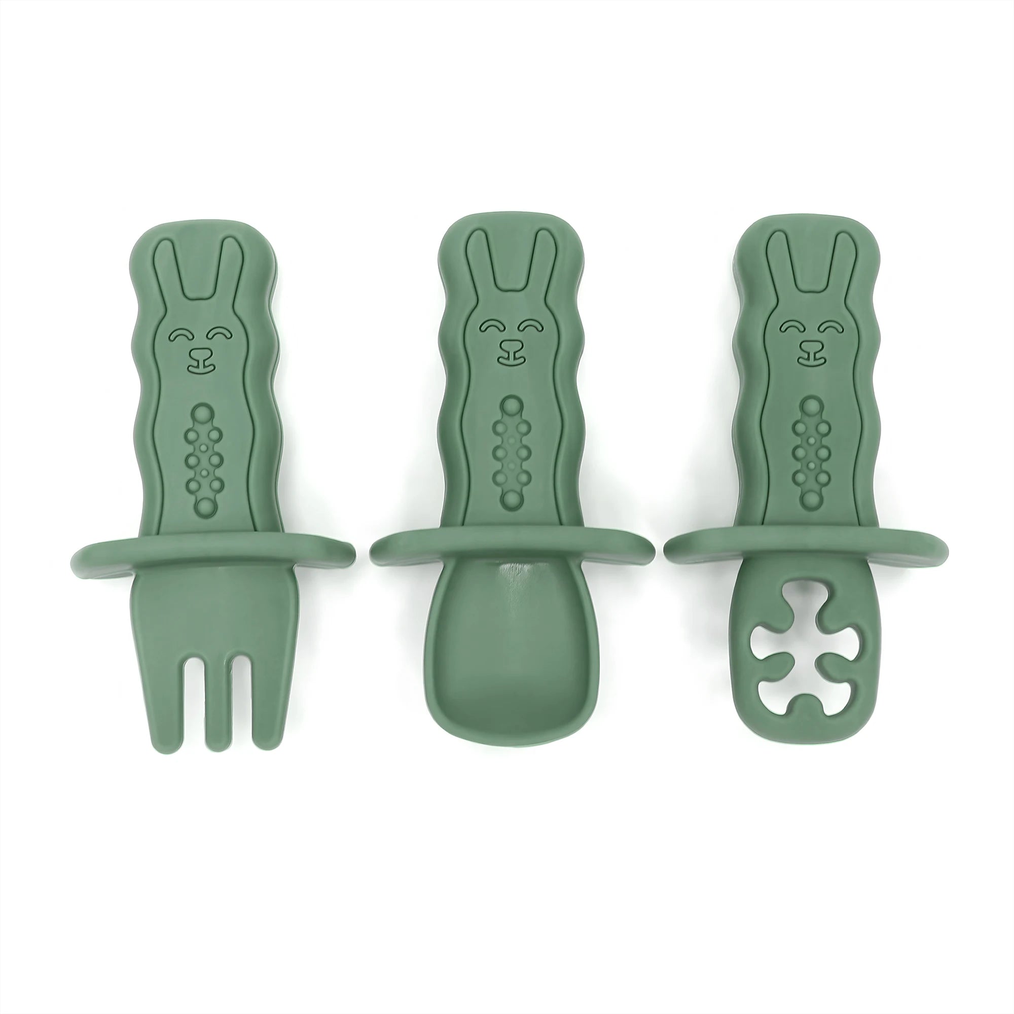 Three green baby utensils with rabbit designs on a white background