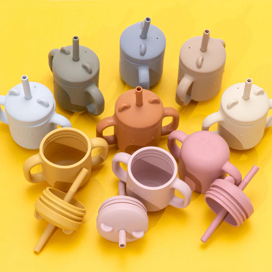 Colorful bear straw cups on a yellow background