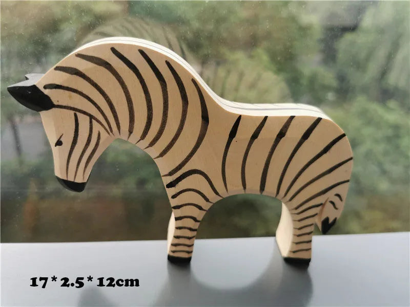 Wooden zebra toy on a reflective surface with a blurred natural background