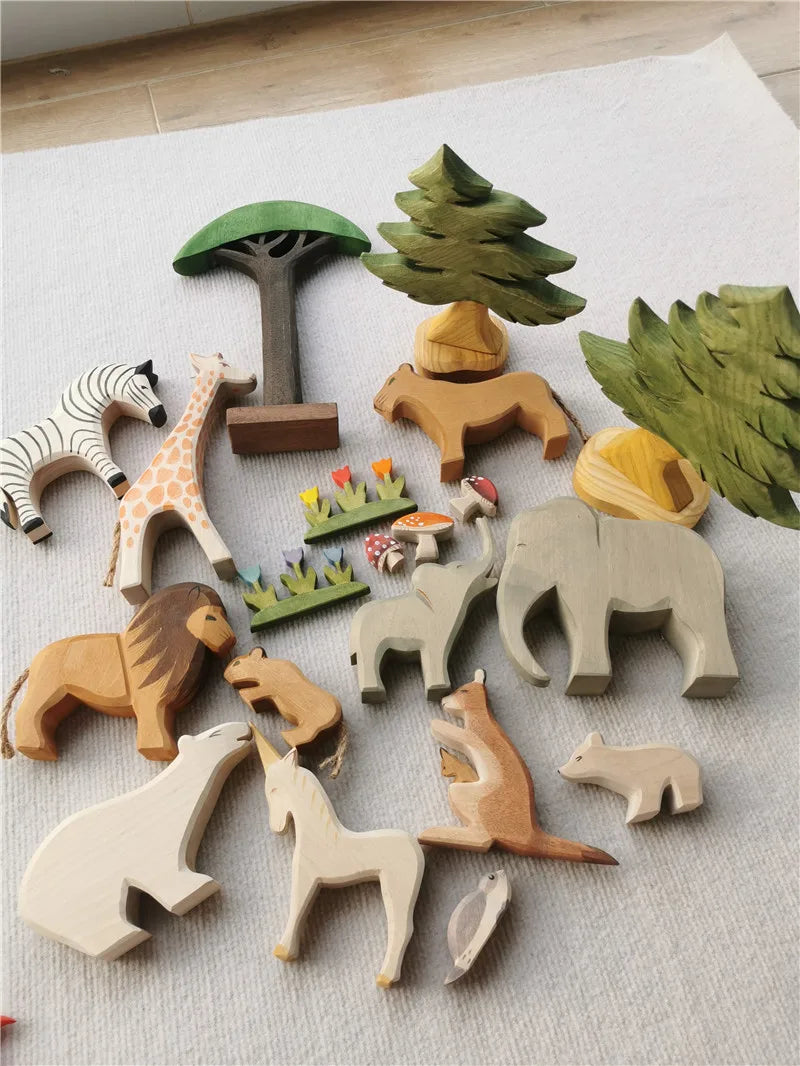 Wooden animal toys and trees on a light gray surface