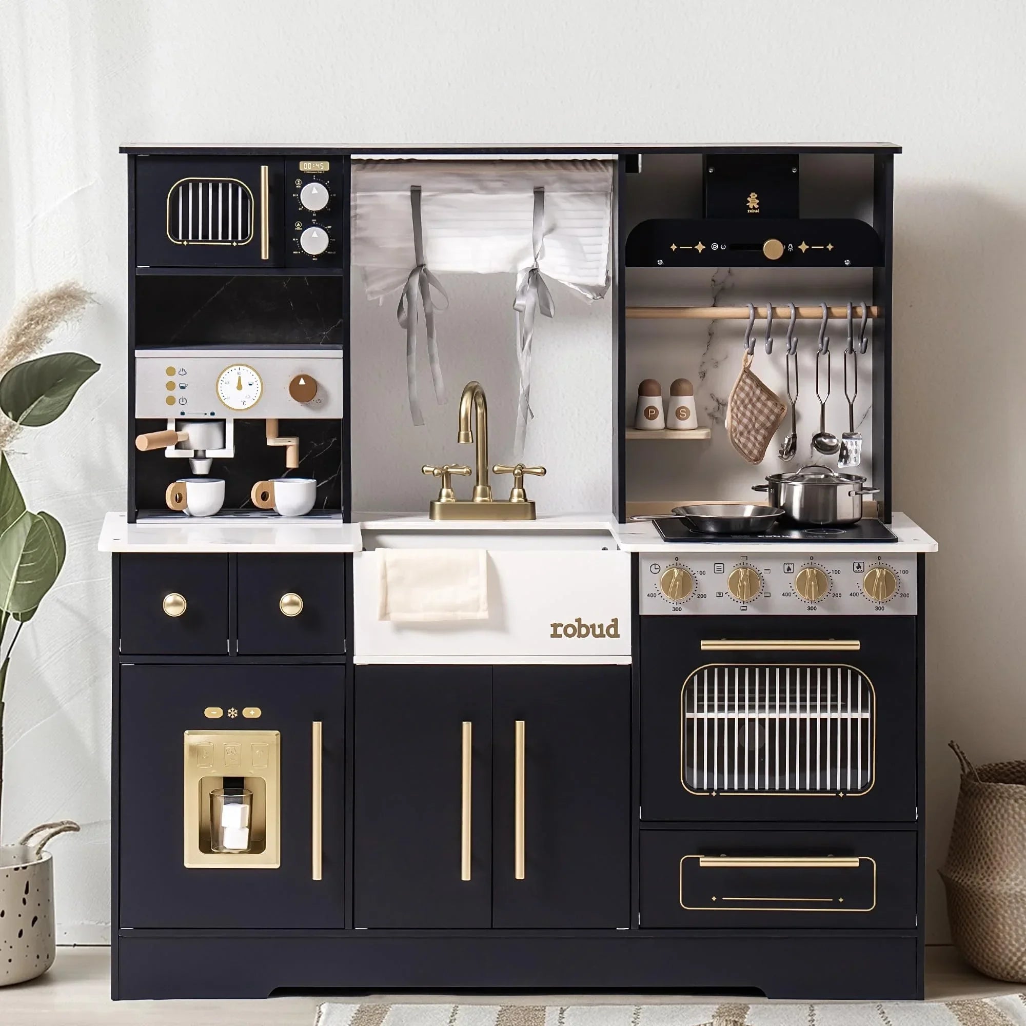 Play kitchen set with black and gold details in a room setting