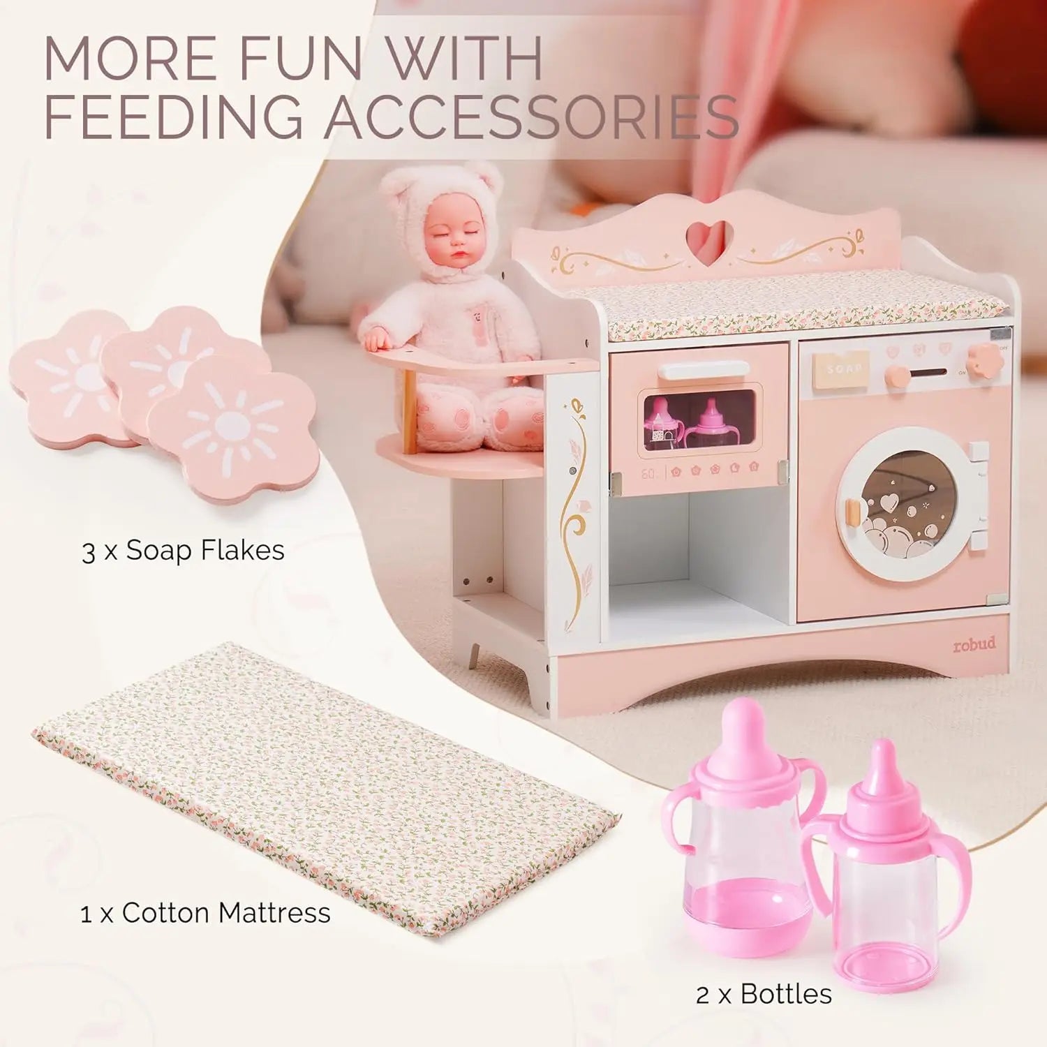 Pink toy kitchen set with doll, soap flakes, cotton mattress, and bottles on a white background.