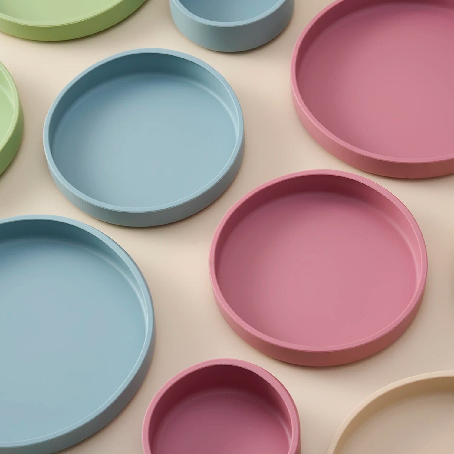 Close-up of blue and rose silicone plates with scoop rims