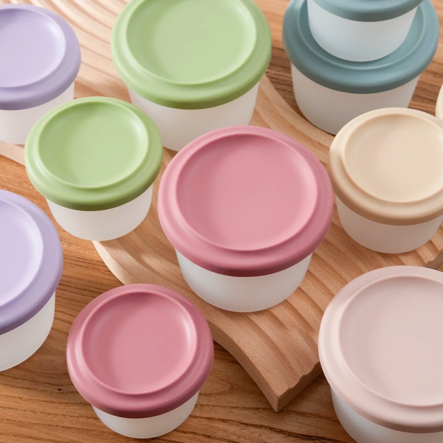 Round silicone food containers with lids in sage, rose, blue, cream and lavender