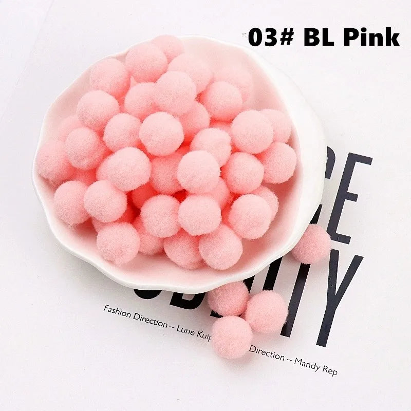 White bowl filled with pink pom-poms on a white background with text.