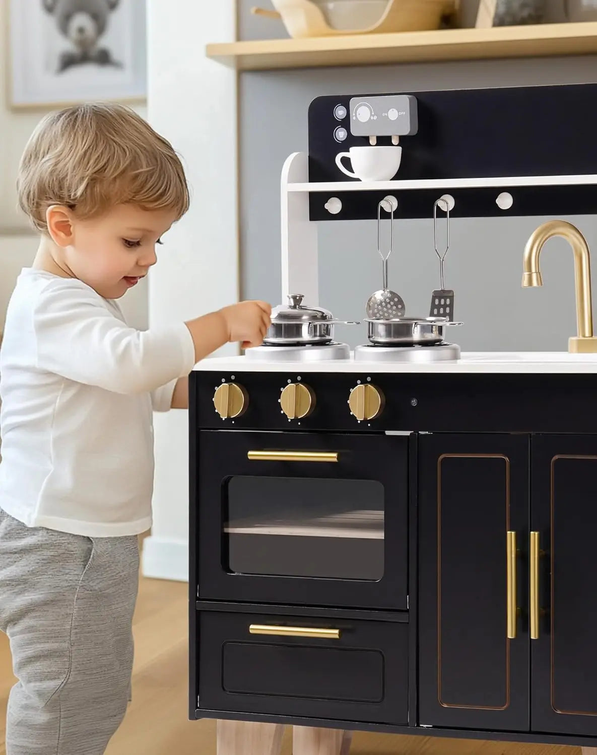Child playing with a toy kitchen set in a home setting