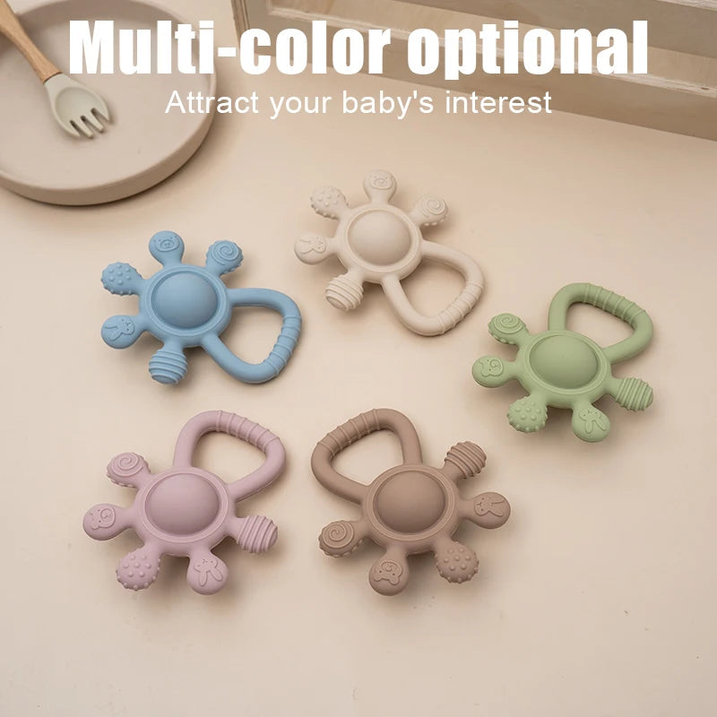 Set of colorful baby teething toys on a neutral background
