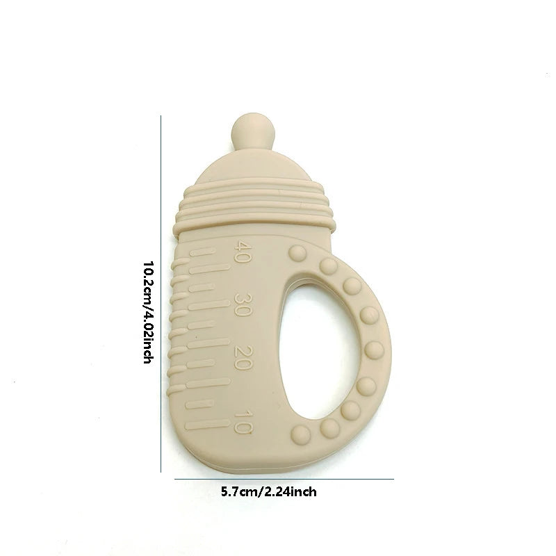 A beige silicone baby teether shaped like a bottle with measurement markings and text showing dimensions of 10.2cm by 5.