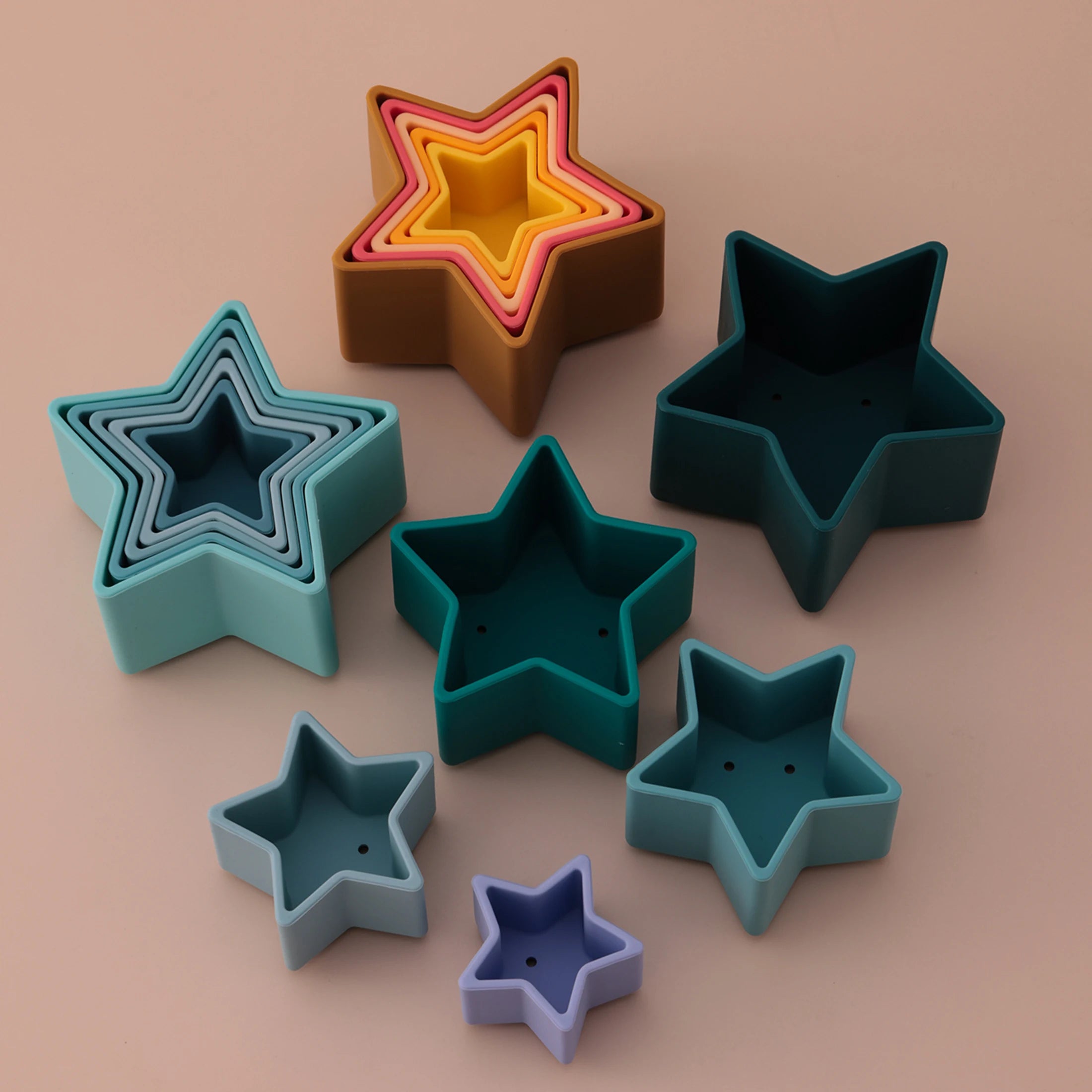 Silicone star cups nested and spread out in teal and green