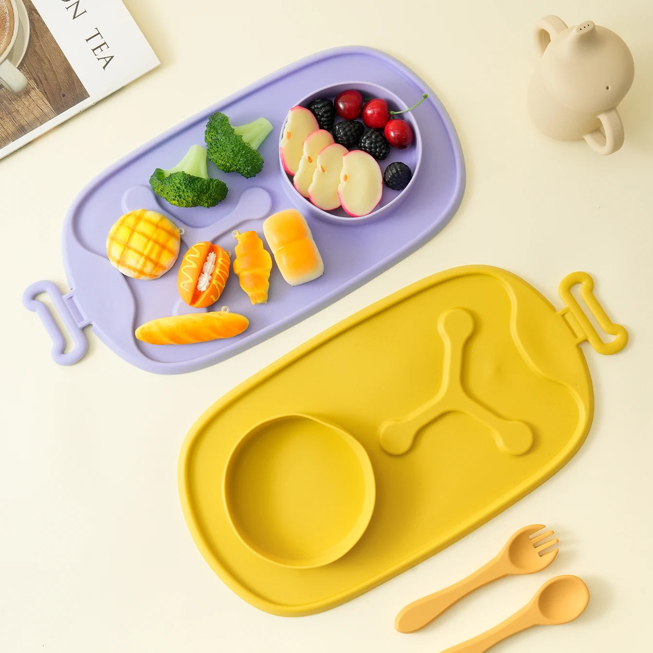 Lavender travel placemat with fruit and vegetables beside a yellow mat
