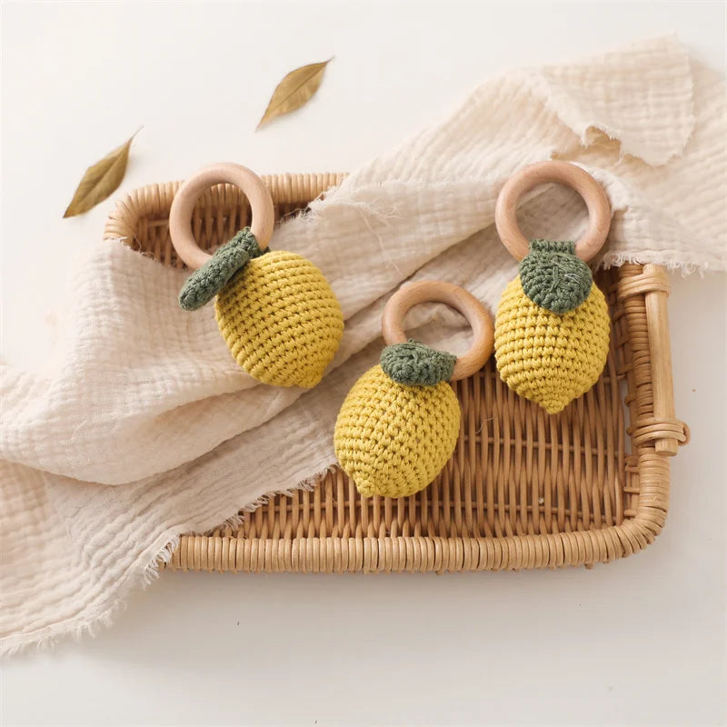 yellow lemon-shaped baby rattles with wooden rings