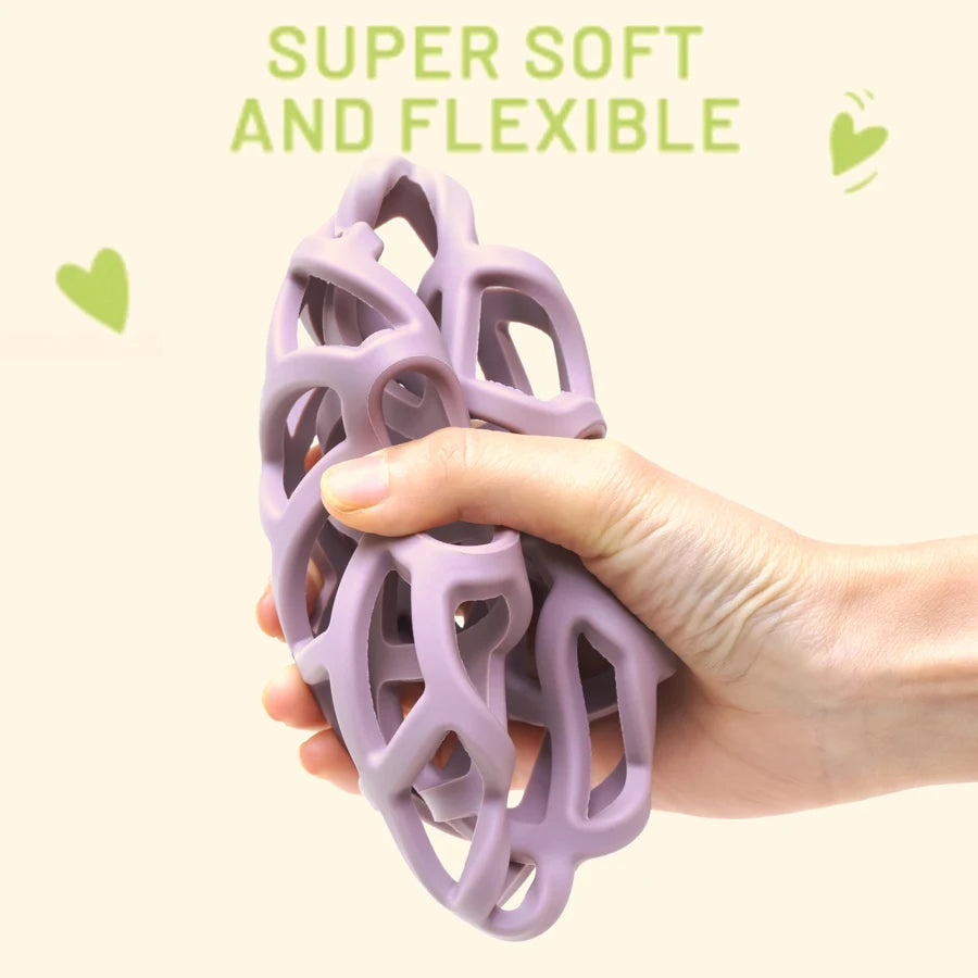 Hand squeezing a soft, flexible lattice teether ball