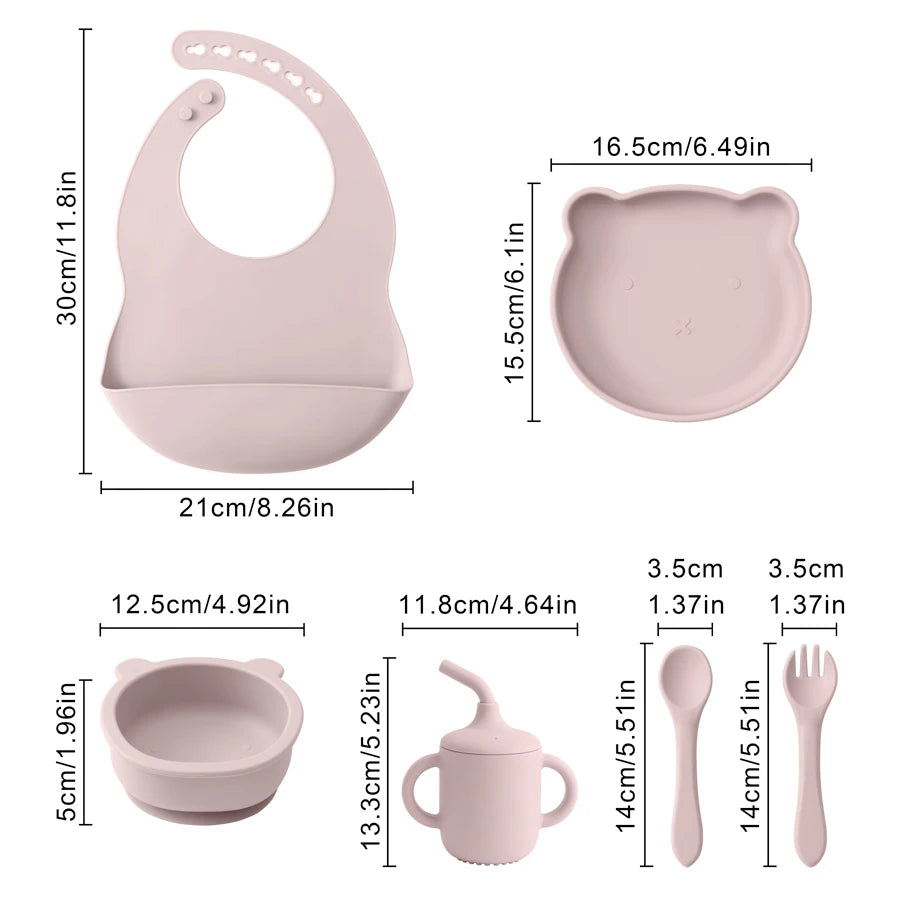 Baby feeding set with bib, plate, bowl, cup, spoon, and fork with measurements on a white background