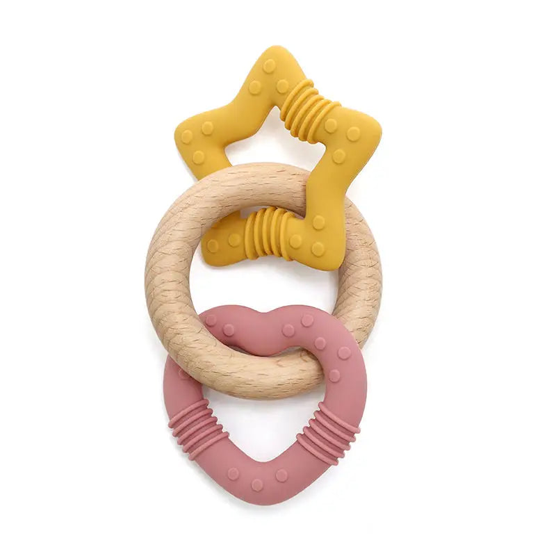 Teething ring with star and heart designs in yellow, beige, and pink on a white background