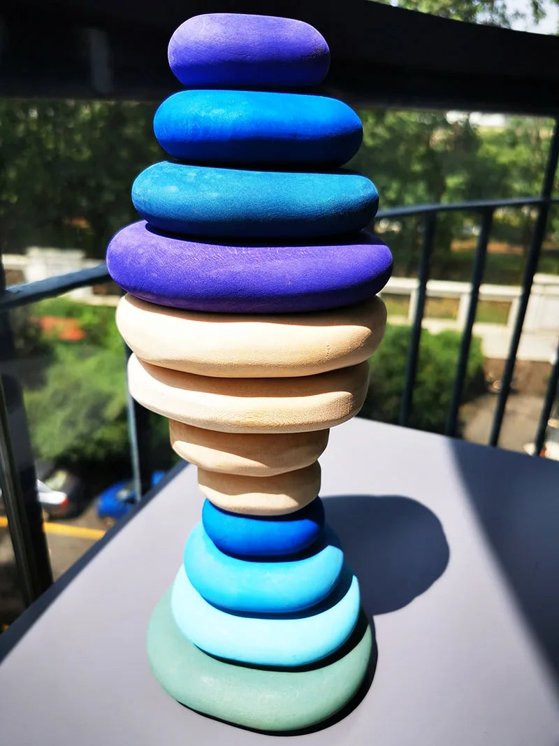 Colorful stacking toy with gradient colors on a reflective surface