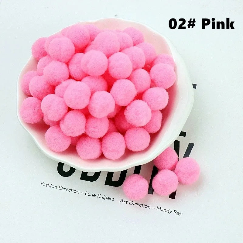 Pink felt balls in a white bowl on a magazine background