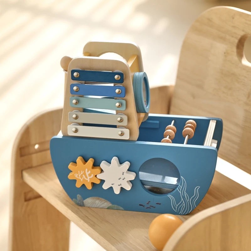 Children's musical toy with xylophone and rattle on a wooden shelf