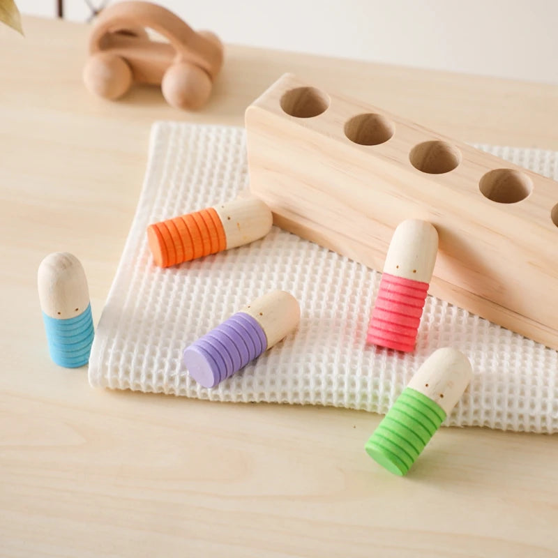 Wooden Bouncing Peg Doll Toy on a table, showcasing its Montessori-inspired design for sensory development and hand strength in early learning.