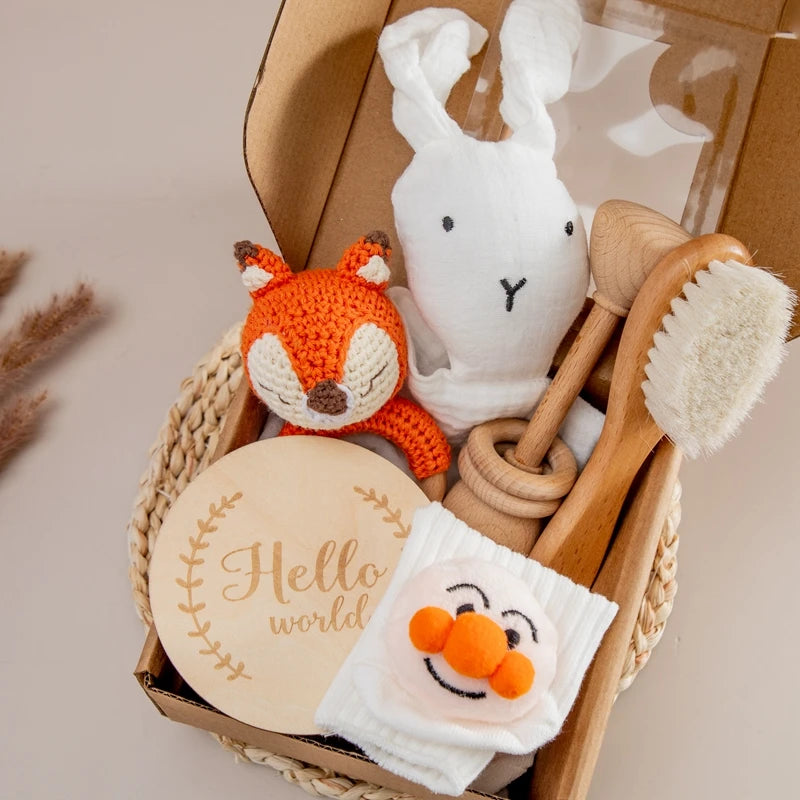 Baby toy set with fox, rabbit, and wooden items in a basket on a neutral background