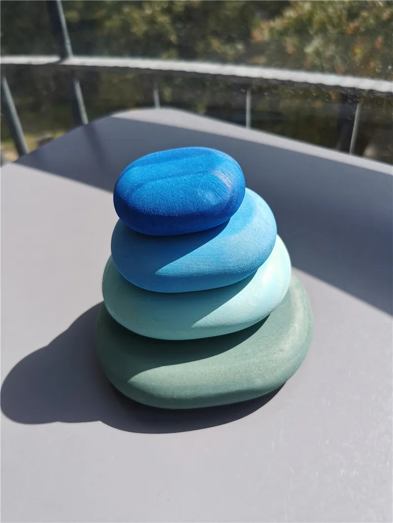 Stack of colorful stones on a flat surface with a blurred natural background