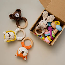 Wooden Baby Rattle Gift Sets with crocheted animal toys, promoting sensory development and creativity for infants, displayed in a decorative box.