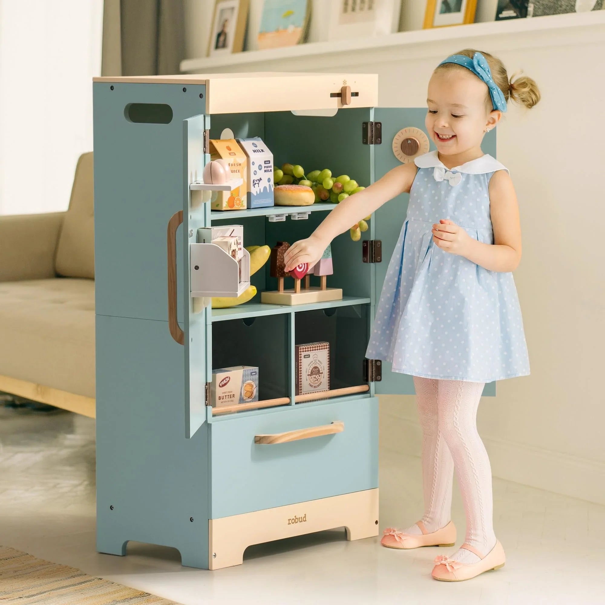 Child playing with a toy kitchen set in a living room