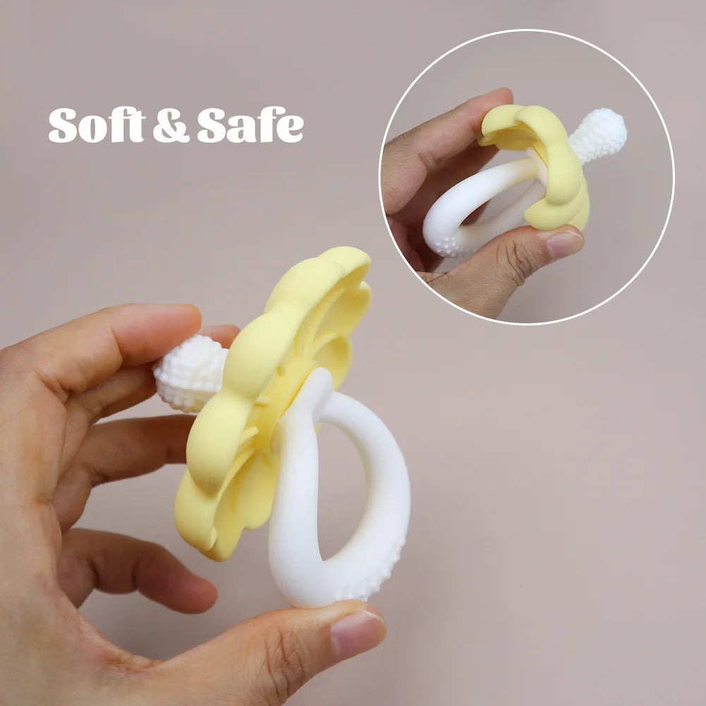 Yellow and white baby teether held by a hand with 'Soft & Safe' text on a plain background.
