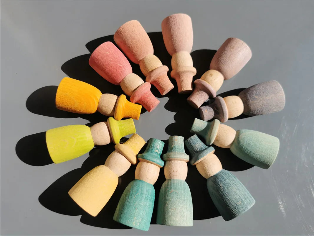 Colorful wooden peg people with hats-shaped objects arranged in a circular pattern on a gray background