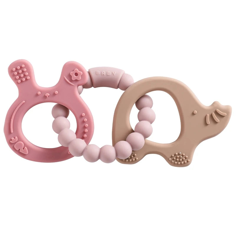 Two silicone teething rings, one pink and one beige, on a white background.