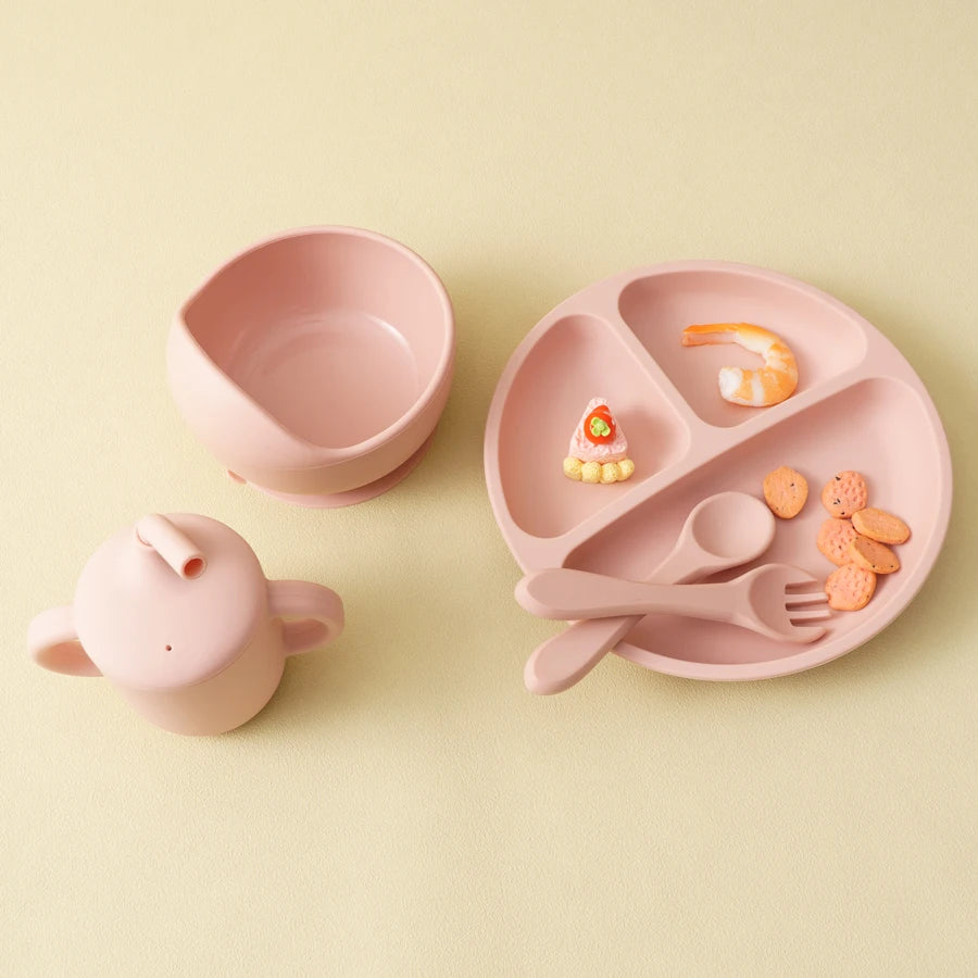 Light pink bowl, straw cup and divided plate with snacks