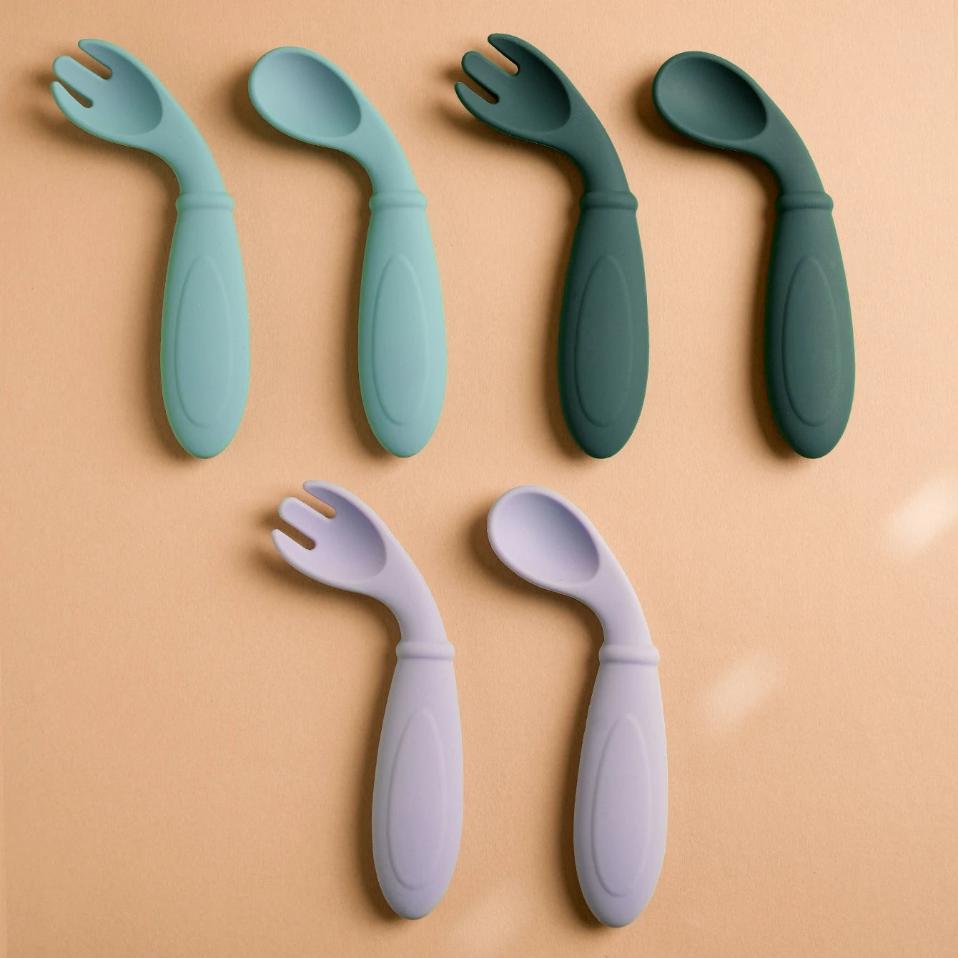 Curved silicone spoons and forks in aqua, dark green and lavender