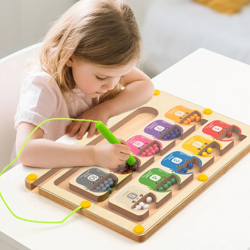 Child playing with a wooden toy maze on a white surface